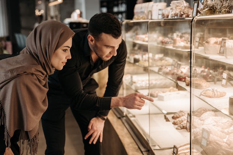 Man And Woman Buying Pastries