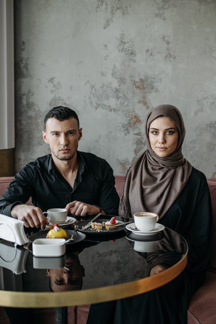 Man And Woman Sitting At Their Table