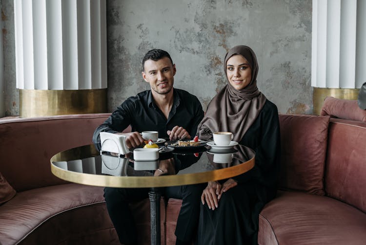 Man And Woman Sitting At The Table