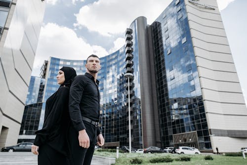 Man and Woman Standing Near Tall Buildings
