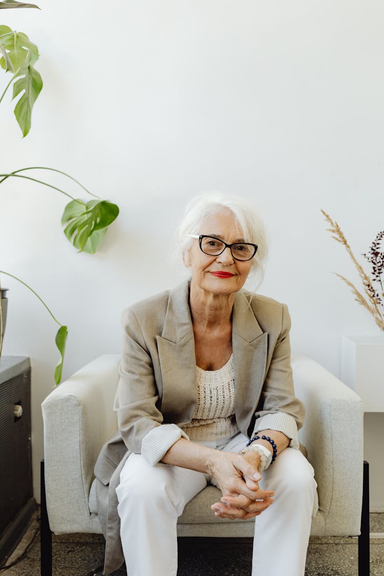 Woman In Gray Blazer Sitting On The Chair