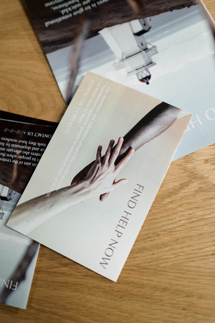 Brochures On A Wooden Table