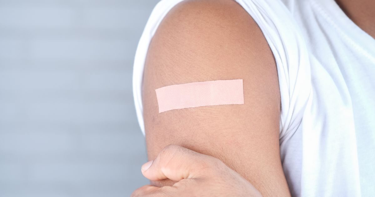 Adhesive patch stuck on a person's upper arm