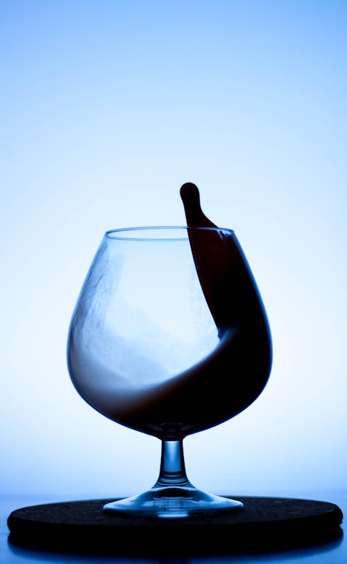 Close-Up Shot of Clear Wine Glass with Black Liquid