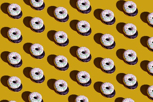 Close-Up Shot of Donuts on a Yellow Surface