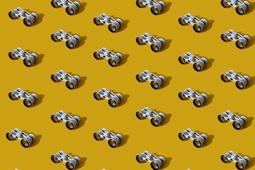 Binoculars on a Yellow Surface