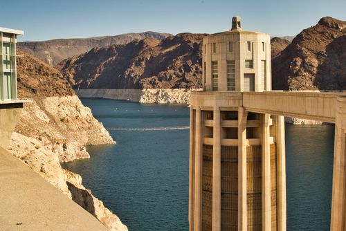 Free Stunning view of Hoover Dam with the reservoir and rocky landscape during a sunny day. Stock Photo