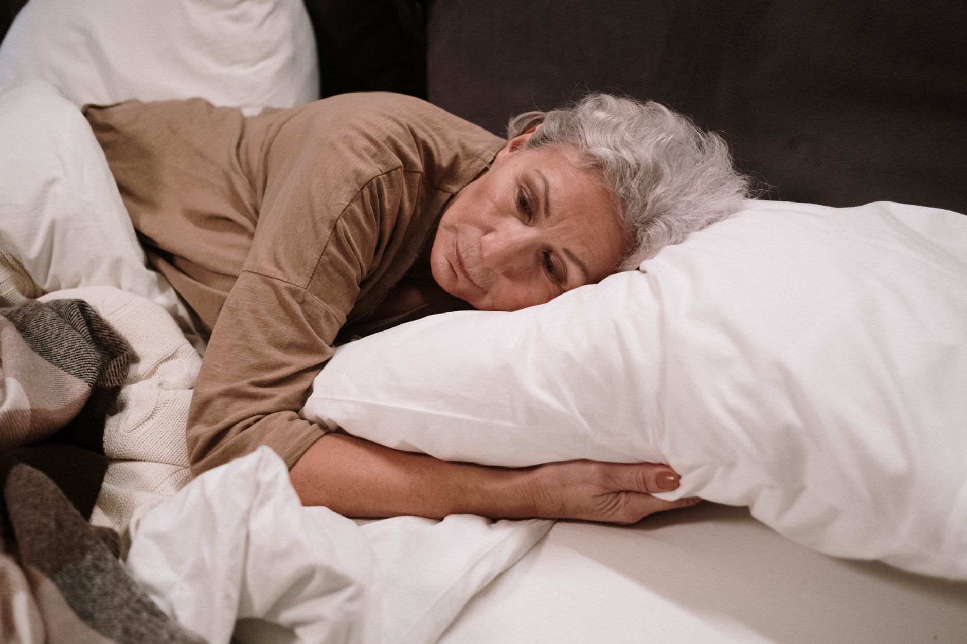 Woman resting in bed after a difficult night of sleep