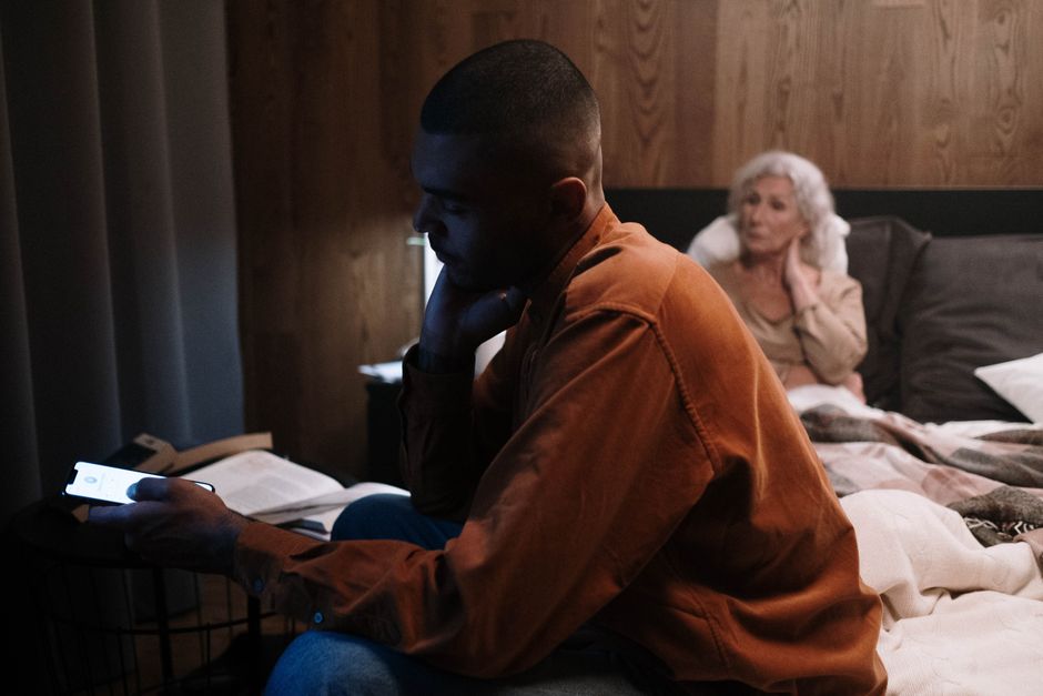 An intimate evening scene with family, showcasing generations connecting indoors with technology.