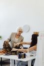 Woman in Gray Cardigan Sitting on Chair