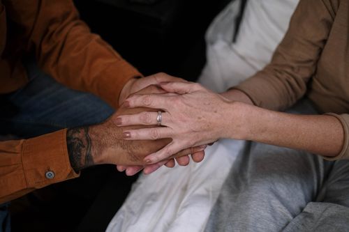 Free Close-up of two people holding hands, symbolizing love and companionship. Stock Photo