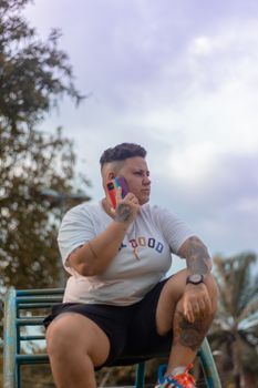 Man in White Crew Neck T-shirt Drinking from Yellow and Blue Can