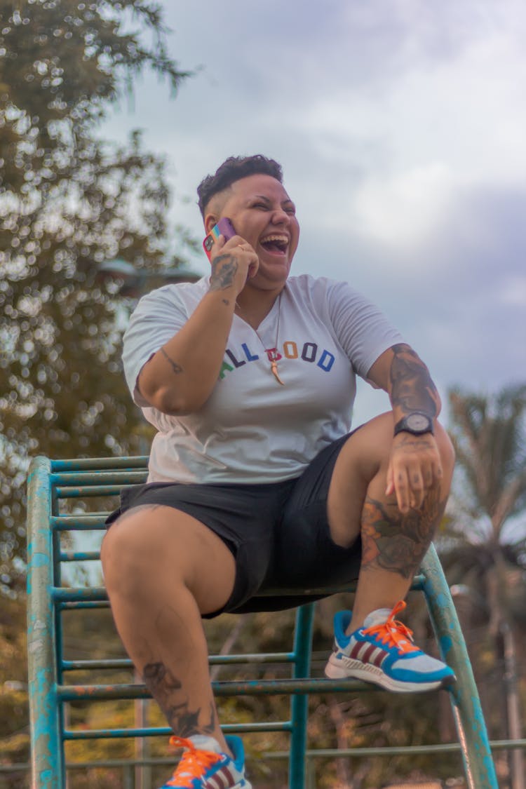 Woman Sitting On Monkey Bars