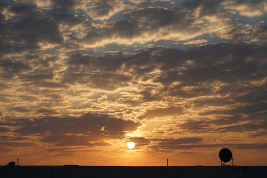 Captivating sunrise with dramatic clouds in Mehsana, India. Perfect for nature lovers.