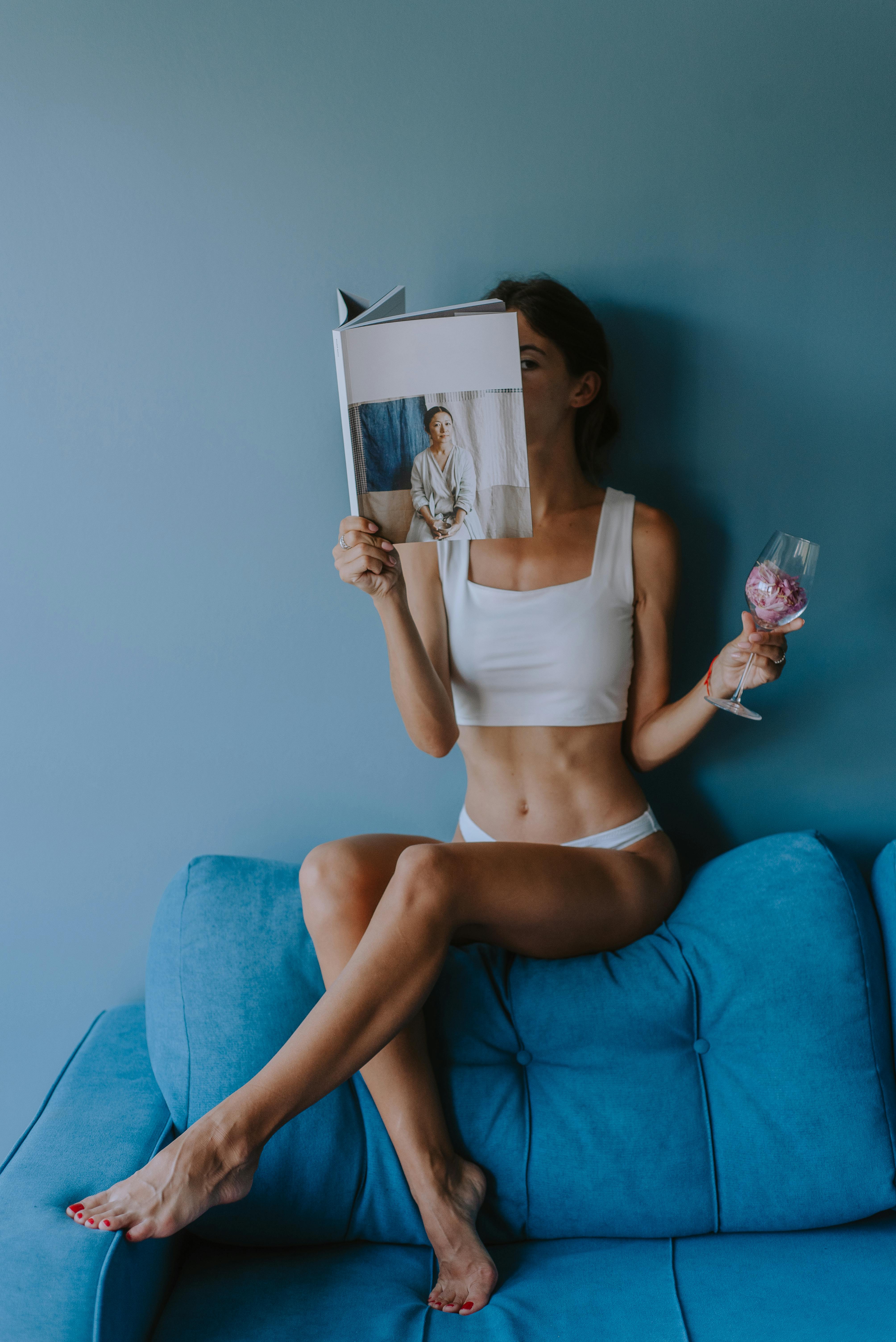Woman in White Tank Top and White Panty Reading a Book · Free Stock Photo