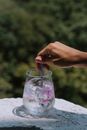 Close-Up Shot of a Person Stirring a Glass of Water