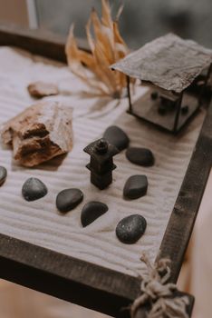 A zen garden with rocks, sand, and wooden elements, promoting tranquility.