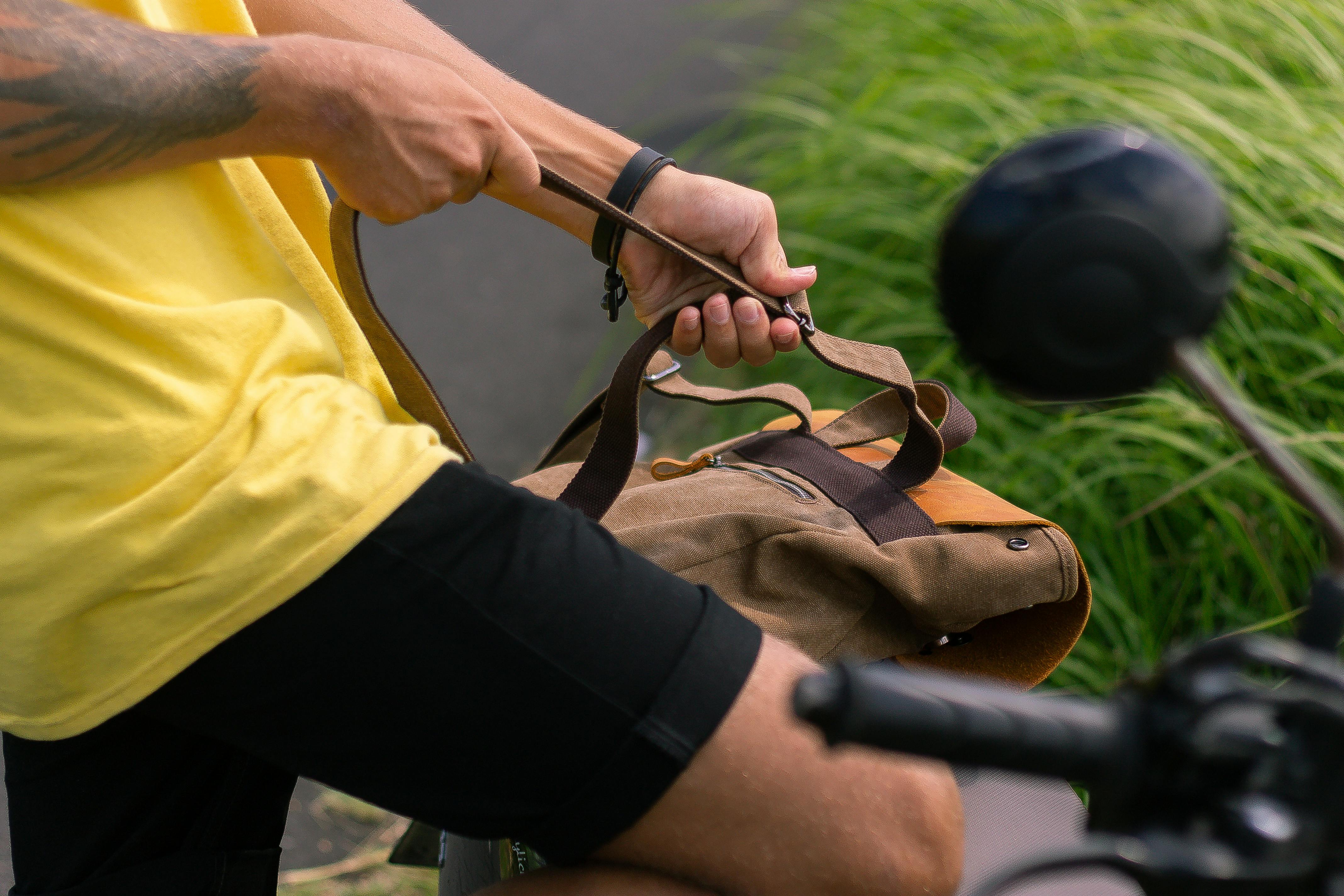 Person Adjusting the Strap of His Backpack · Free Stock Photo