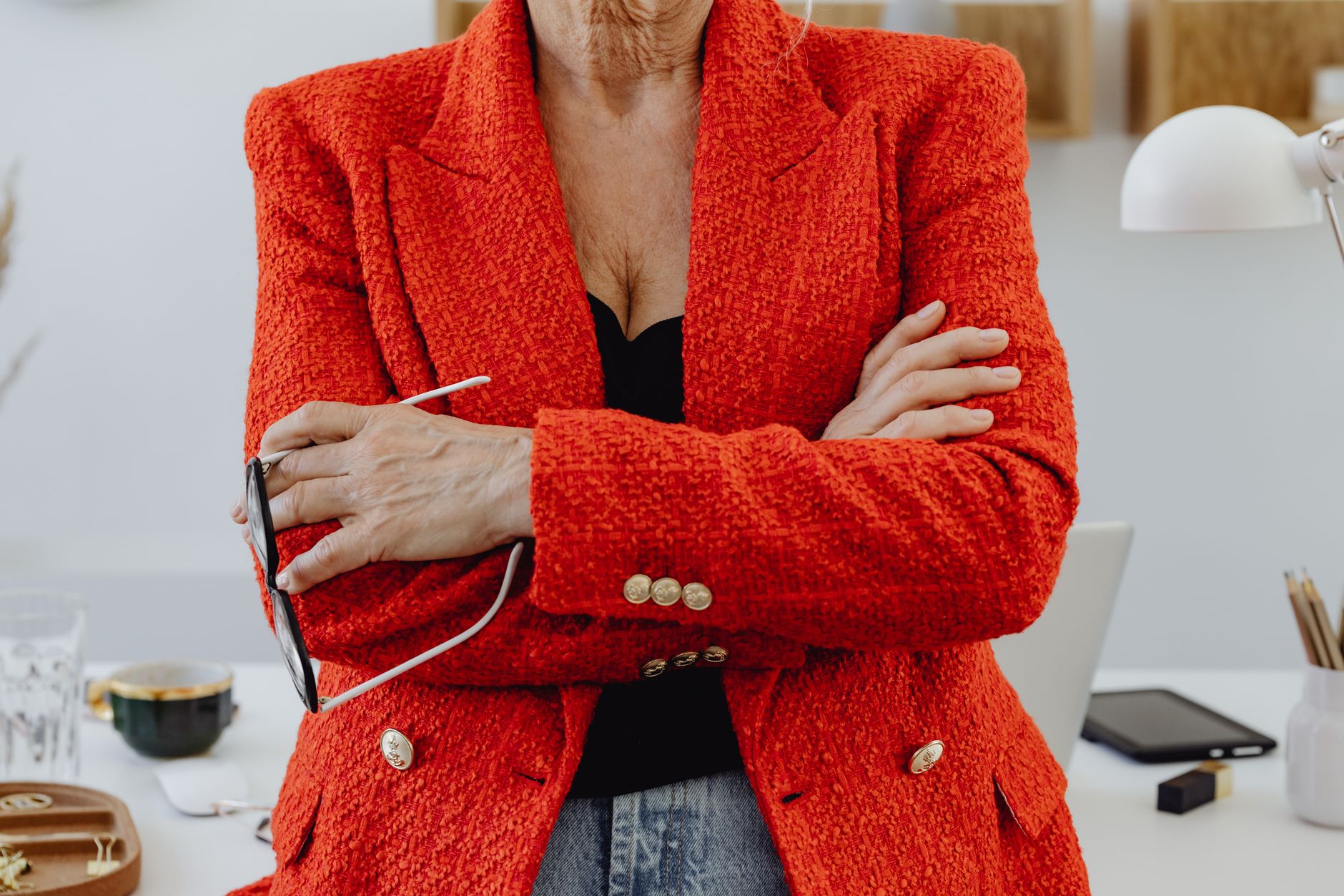 Close-up comparison of a structured blazer shoulder with visible padding and an unstructured jacket shoulder with soft natural drape