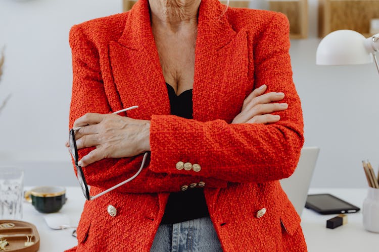 Woman In Red Blazer Holding Eyeglasses