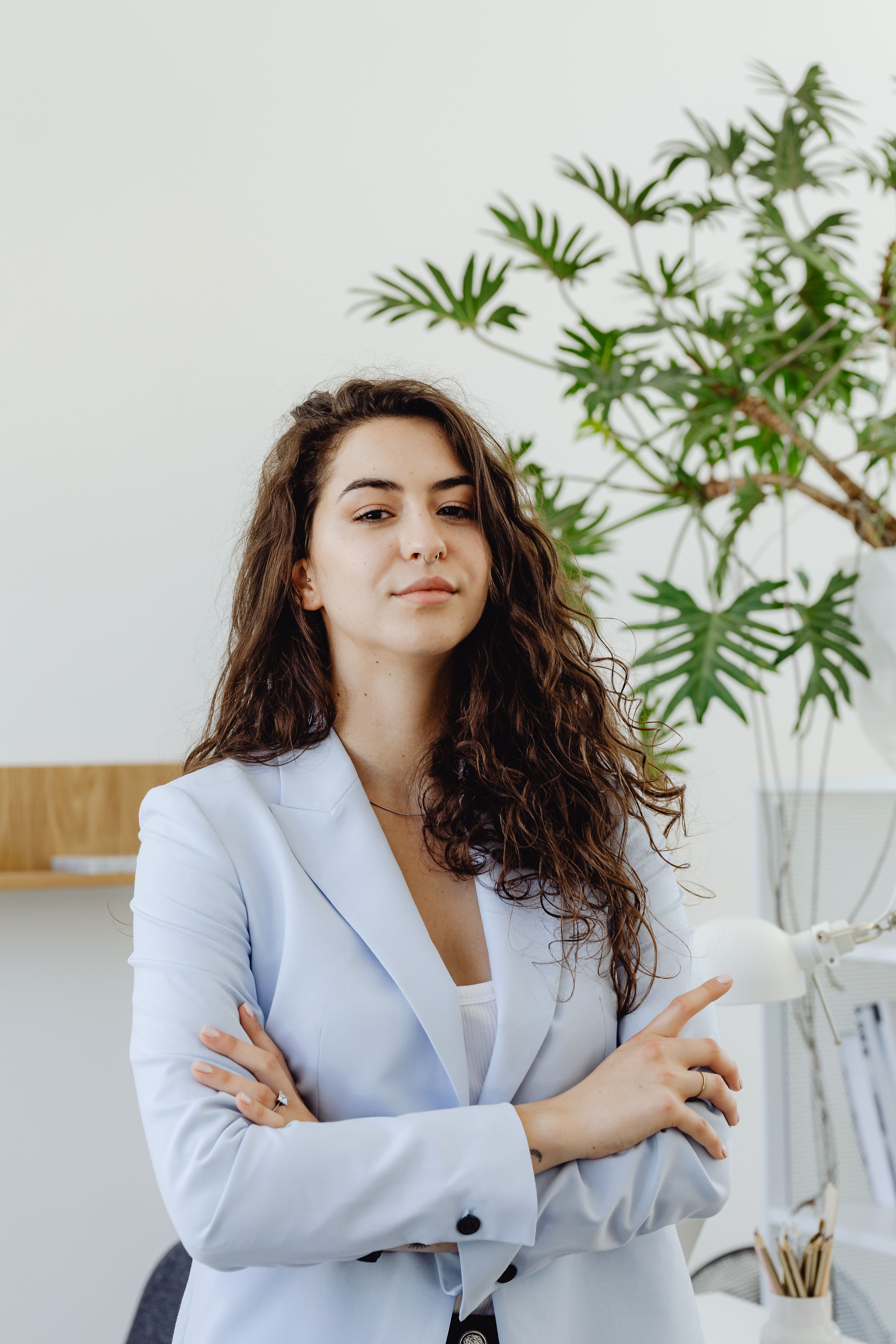 A Woman in White Blazer Looking with Her Arms Crossed · Free Stock Photo