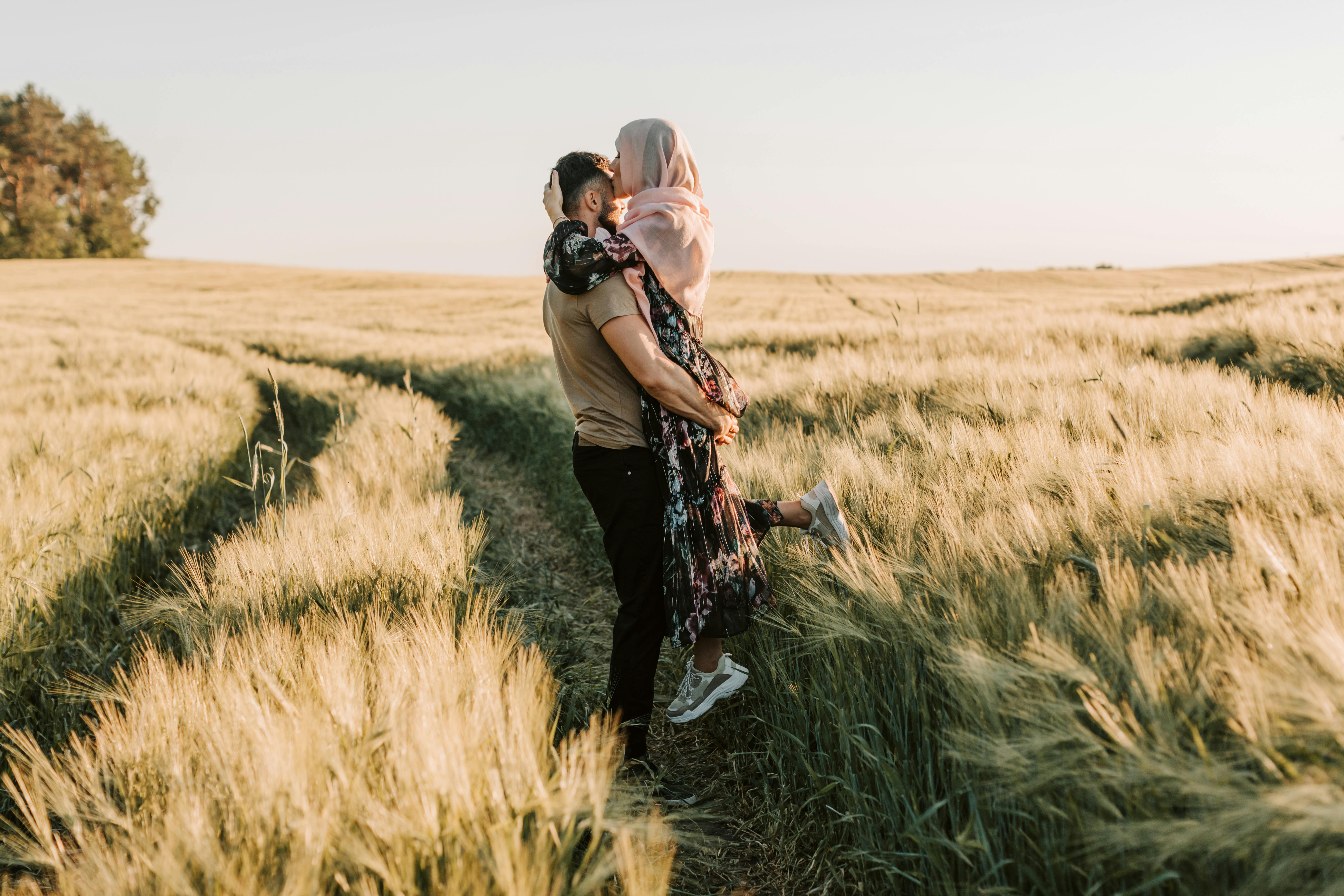 a couple in the grass field