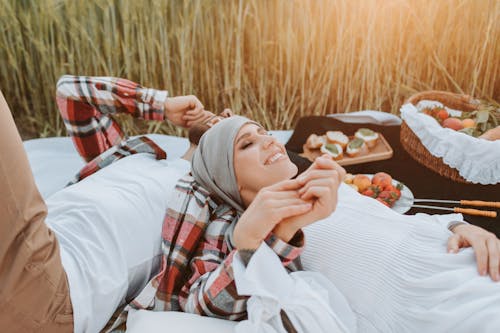 Free Couple Lying on Picnic Blanket Stock Photo