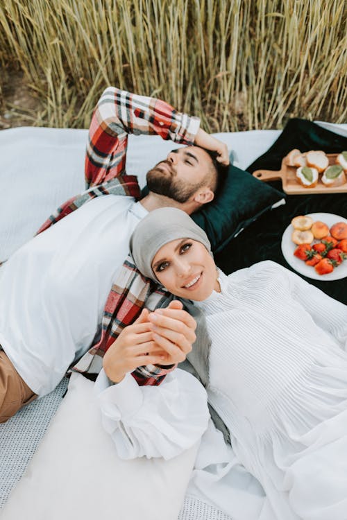 Free Beautiful Couple Lying Together on a Blanket Stock Photo