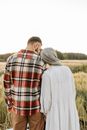 Man and Woman Standing on Green Grass Field