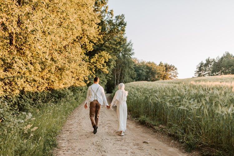 Back View Of A Couple Walking In The Countryside