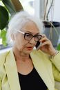 A Woman in Yellow Blazer Talking on the Phone