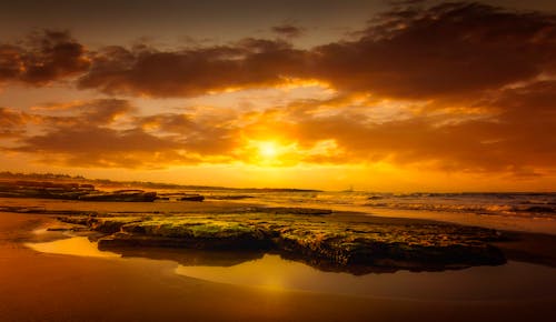 Beautiful Sunset Over Body of Water