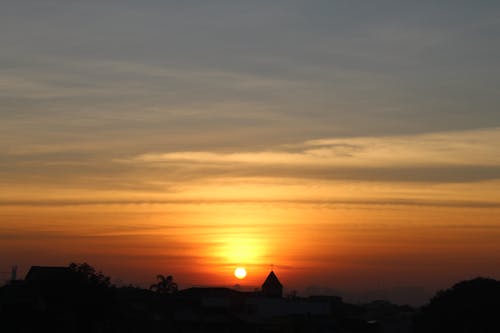 Silhouette of Houses during Sunrise