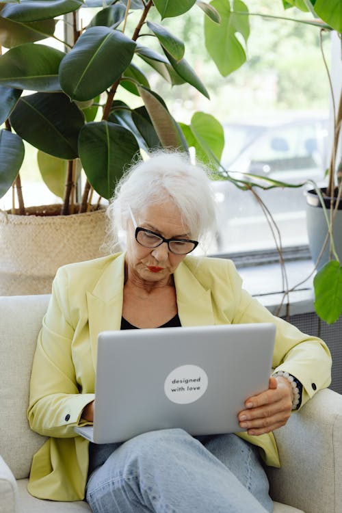 A Woman in Yellow Blazer Using Laptop