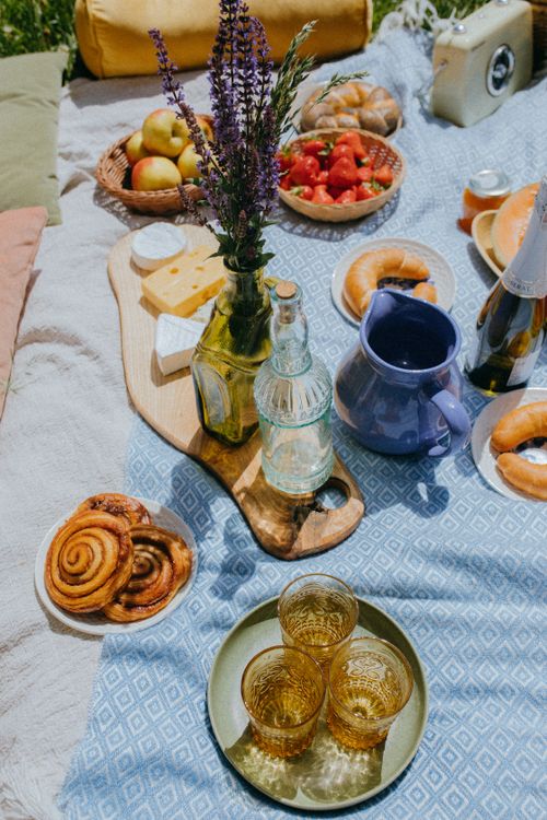 Free Enjoy a delightful summer picnic with pastries, fruits, and drinks on a sunny day. Stock Photo