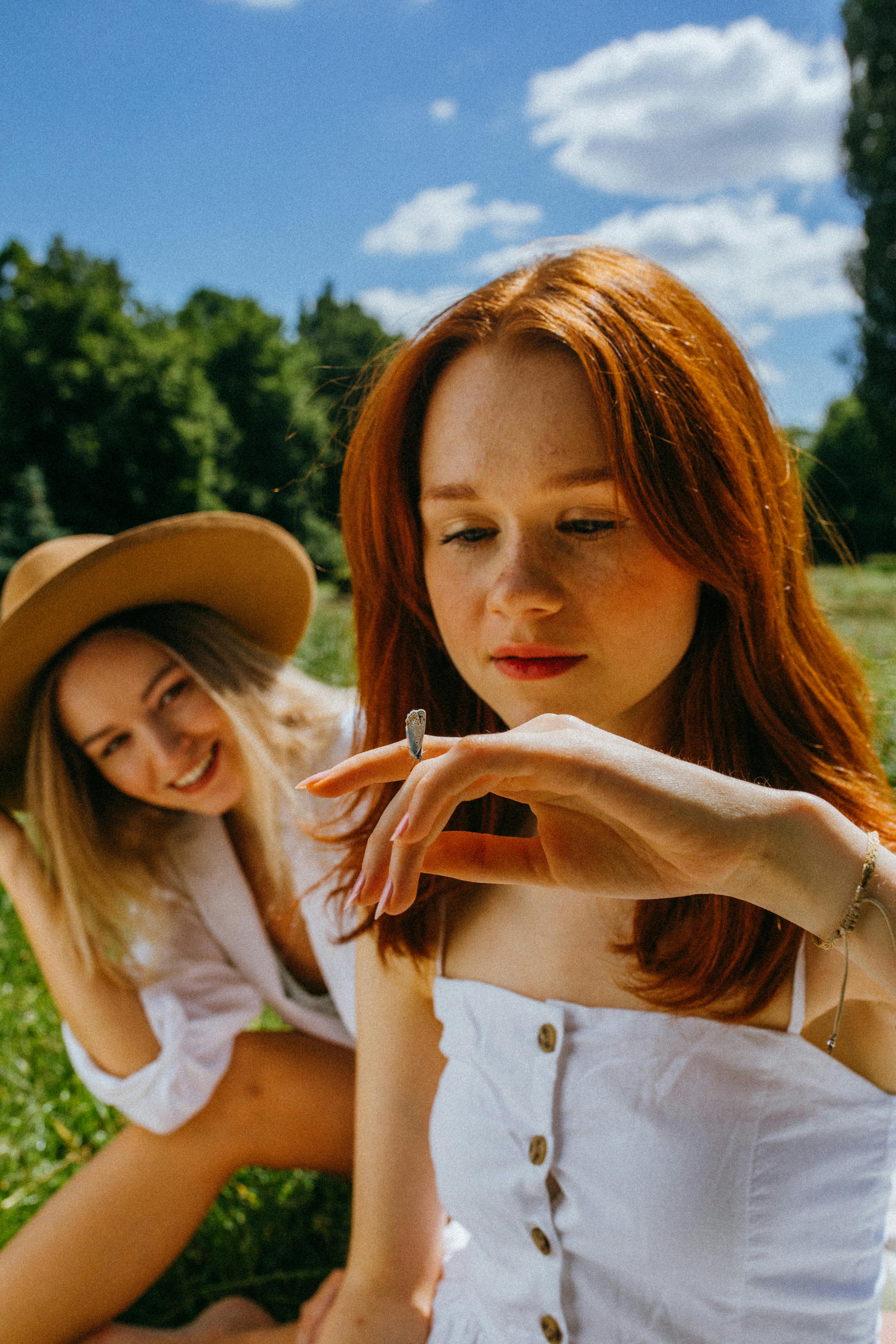 Two young women enjoying a sunny day, embodying friendship and relaxation.