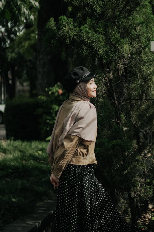 A Woman in Brown Hijab Wearing Black Cap