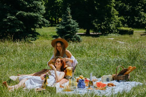 Two Young Women Having a Picnic in a Park