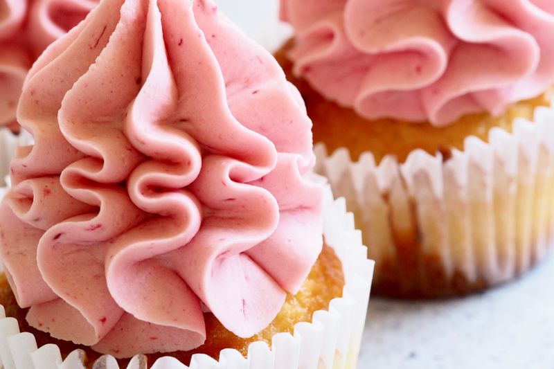Delicious close-up image of pink-frosted cupcakes, perfect for dessert enthusiasts.