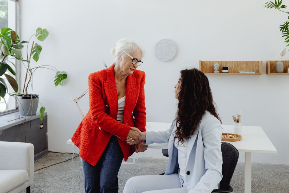 full|business women shaking hands