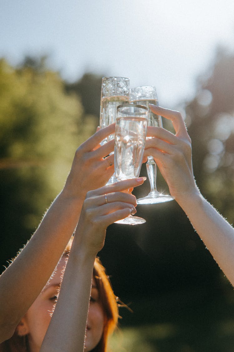 People Tossing Their Glasses