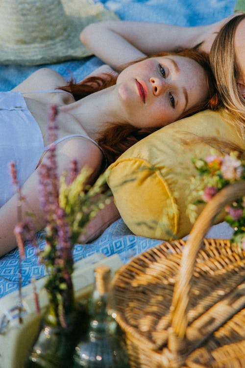 Free A Woman Lying on a Picnic Blanket Stock Photo