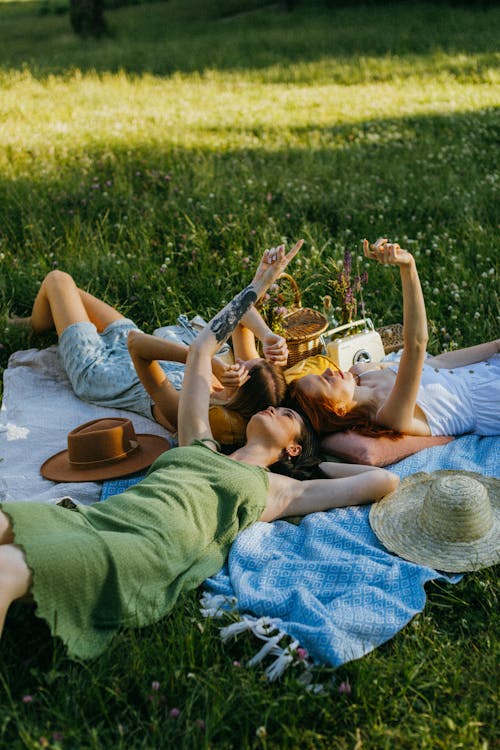 Free Women Lying Down over Picnic Blankets Stock Photo