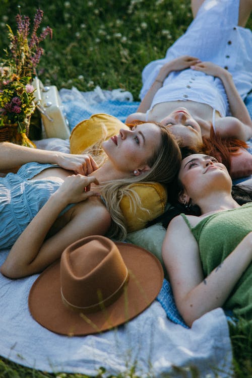 Free Women Lying Down over Picnic Blankets  Stock Photo
