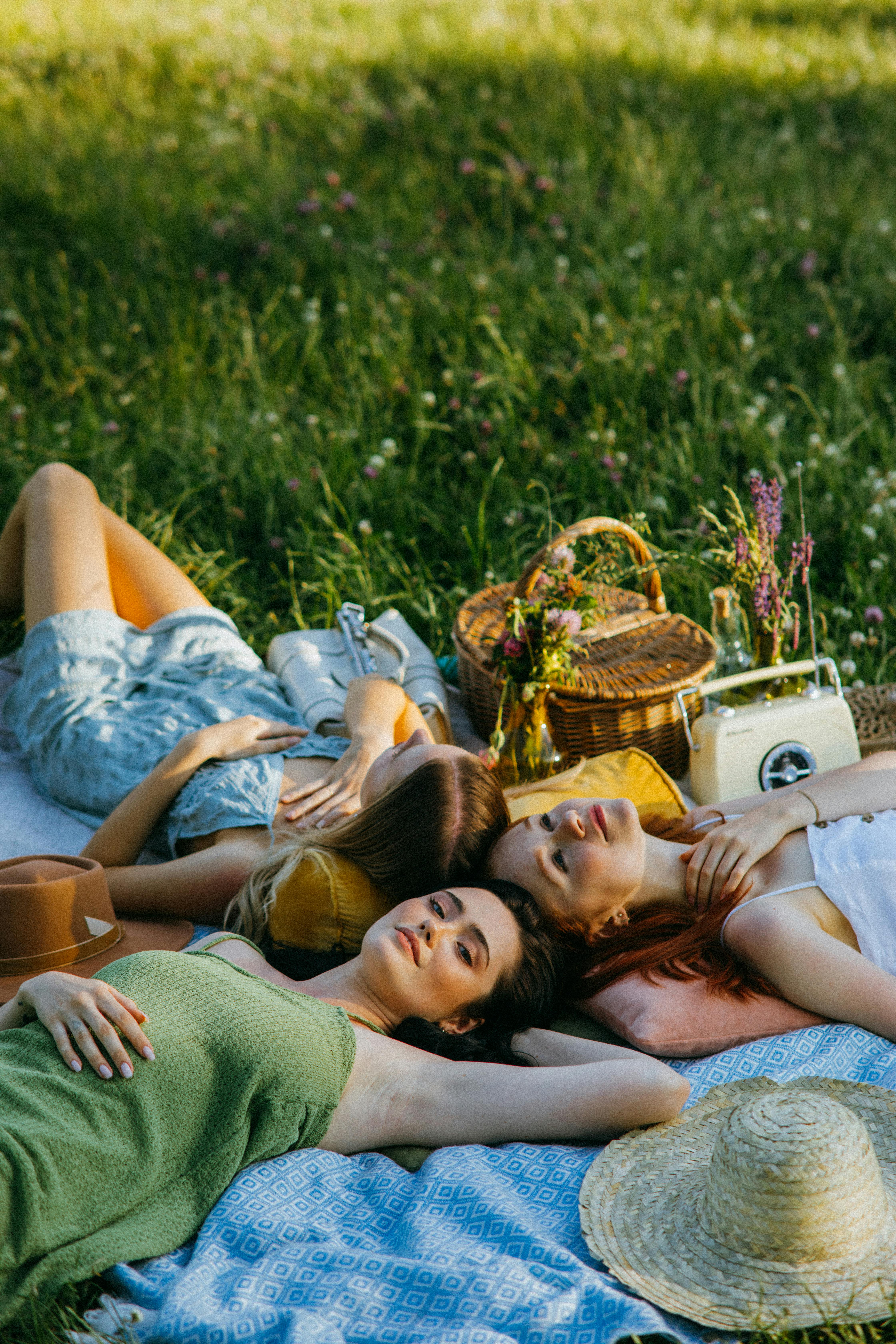 a group of friends lying on the picnic blanket