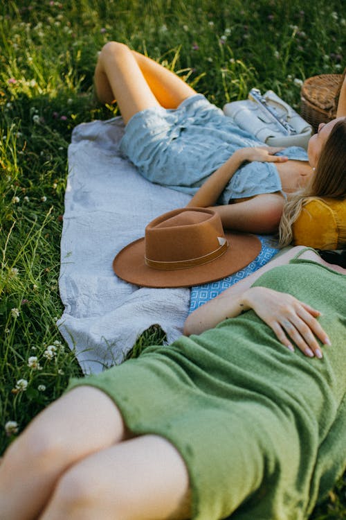 Women Relaxing by Lying Down over the Picnic Blankets