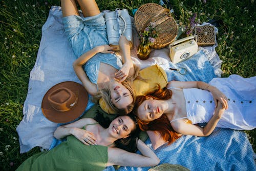 A Group of Friends Lying on a Picnic Blanket