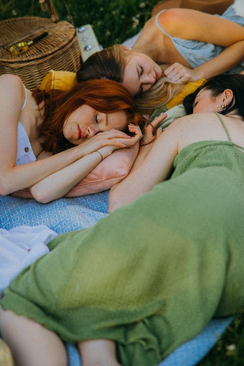 Free Women Lying Down on a Picnic Blanket Stock Photo