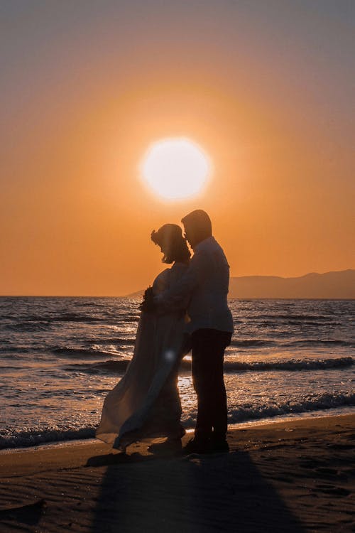 A Couple Hugging on a Beach