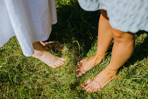 A Close-Up Shot of Bare Feet on Grass